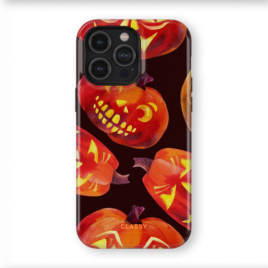 Phone case with Halloween-themed design featuring jack-o'-lanterns on a dark background