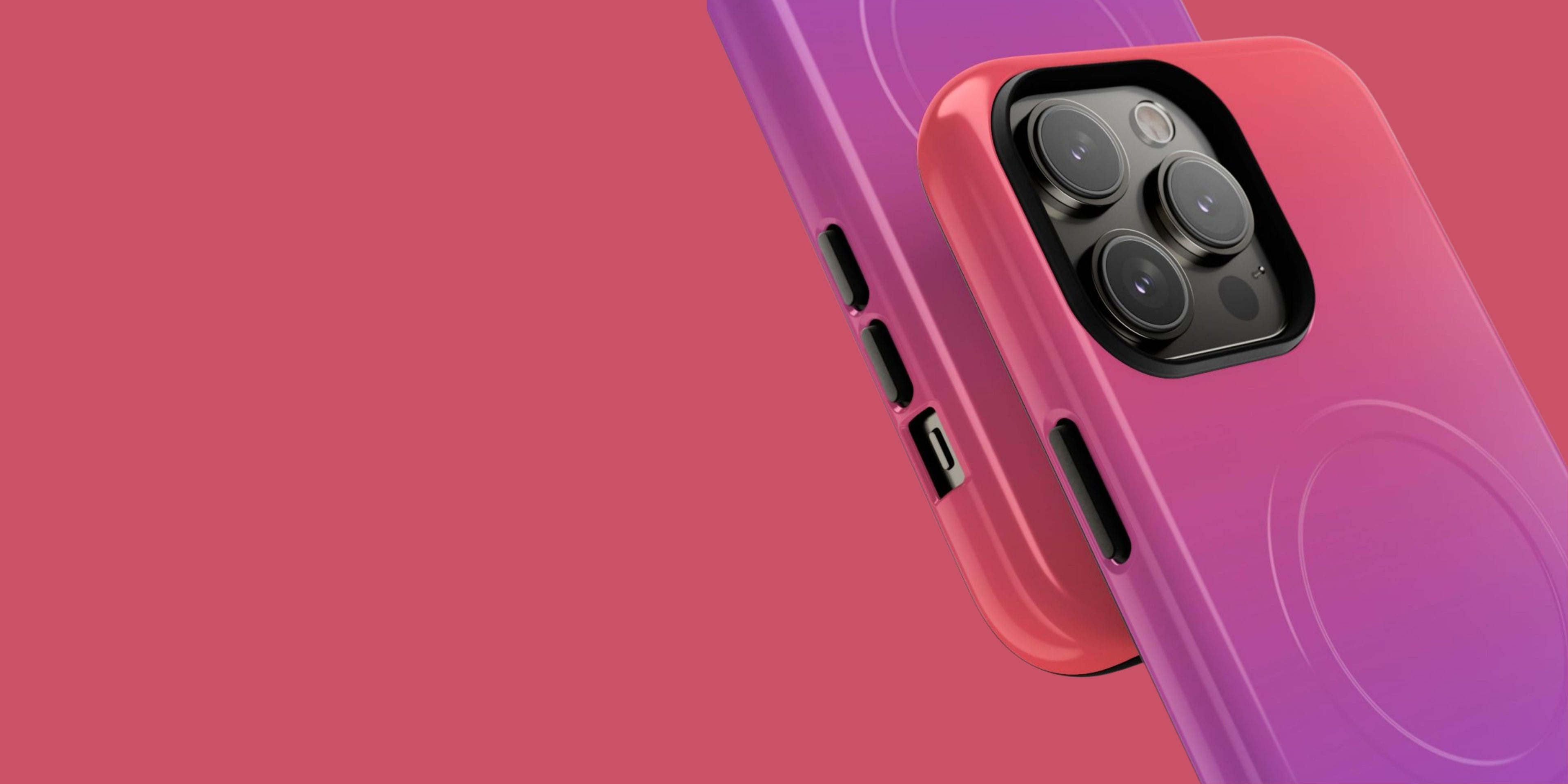 Two smartphones with gradient designs on a pink background